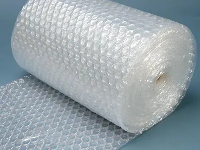 Clear bubble wrap roll partly unrolled, protective packaging for fragile items