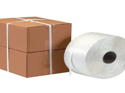 White polyester cord strap roll next to cartons strapped with cord strap