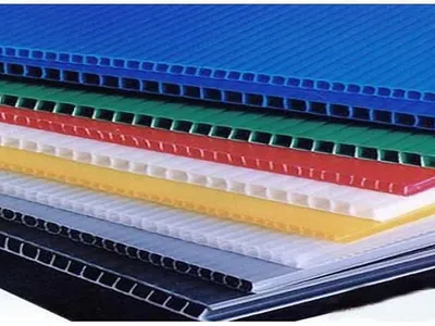 Stacked corrugated PP floor protection sheets in blue, green, red, yellow and white